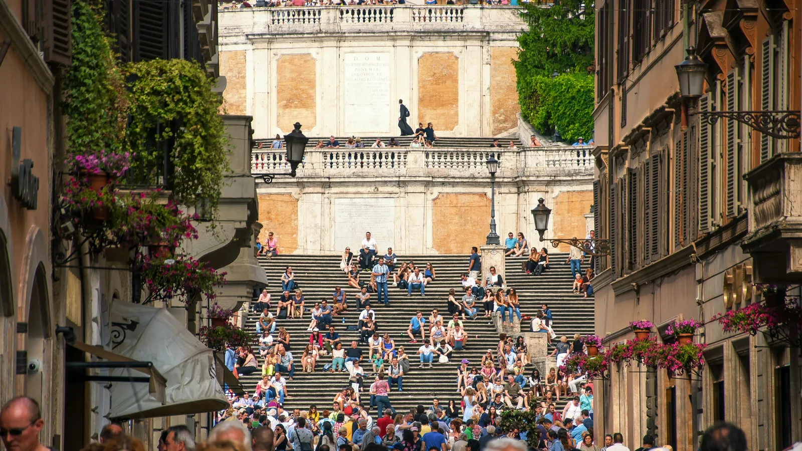 Evening light on Piazza della Madonna dei Monti — the 16th-century Della Porta fountain and the cobblestoned square that anchors Rione Monti, three minutes from Hotel Colle Oppio.
