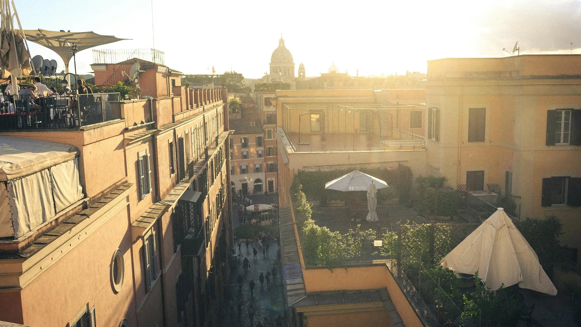 Rooftop terrace view over Roman rooftops at golden hour from Hotel Colle Oppio